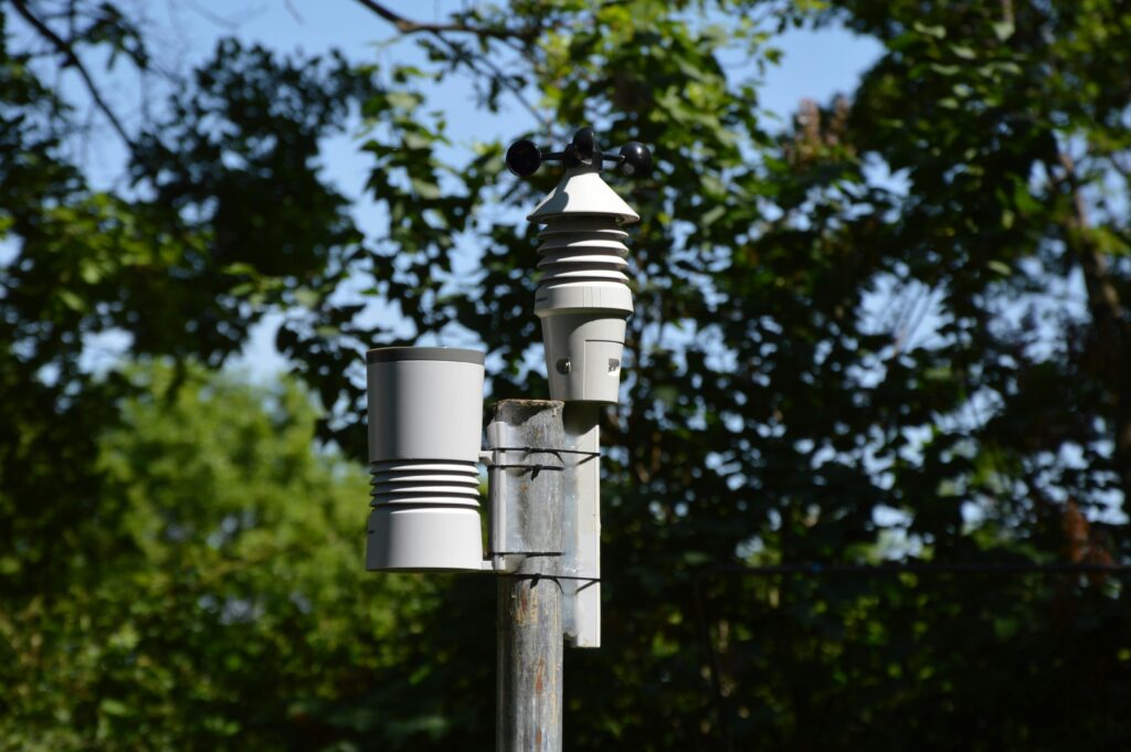 Close-up of an anemometer and weather device on a sunny day outdoors.