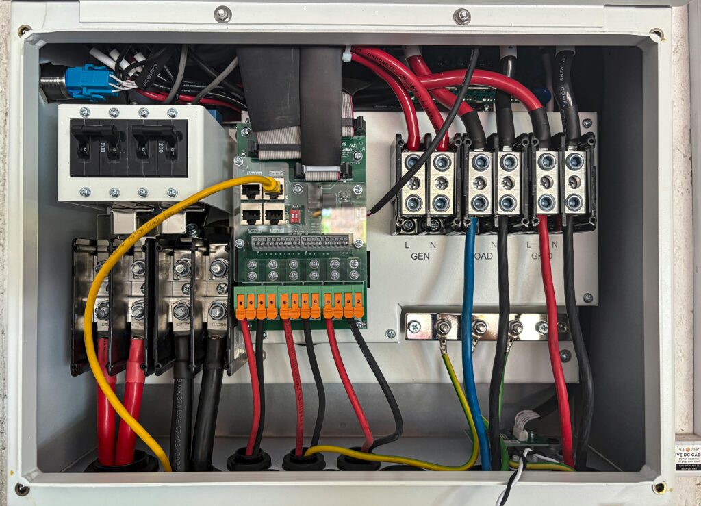 Inside view of an electrical control panel showing circuits and connections.